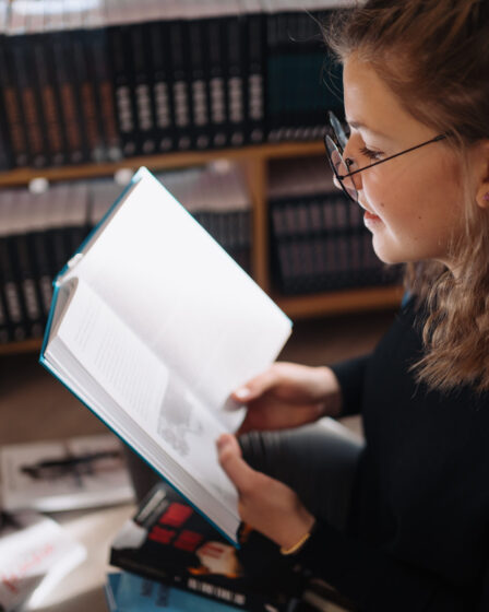 Young woman reading a book, home lifestyle advice and how-to guides