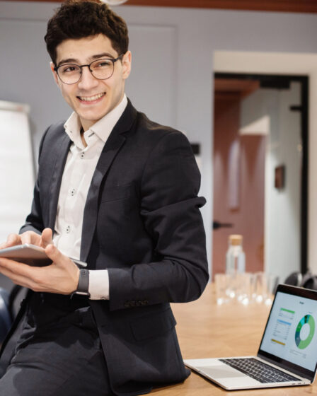 Professional with glasses and tablet discussing career advancement and personal development.