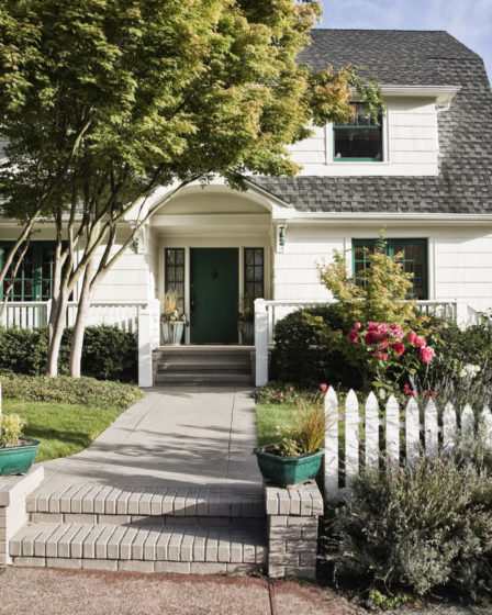 Remodeled older-style home exterior with landscaping and inviting front porch.