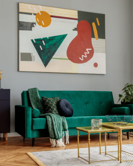 Luxury home interior design with green velvet sofa and modern art.