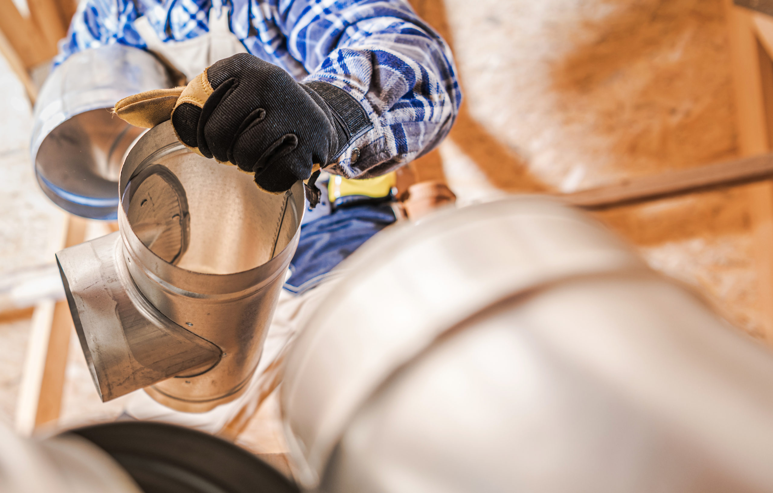 HVAC technician sealing air ductwork joints for improved efficiency