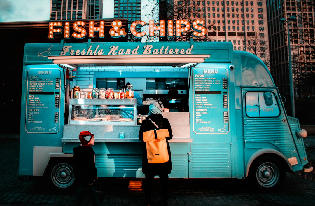 Mobile kitchen food truck with menu and display case, illustrating technology and location needs for a mobile restaurant.