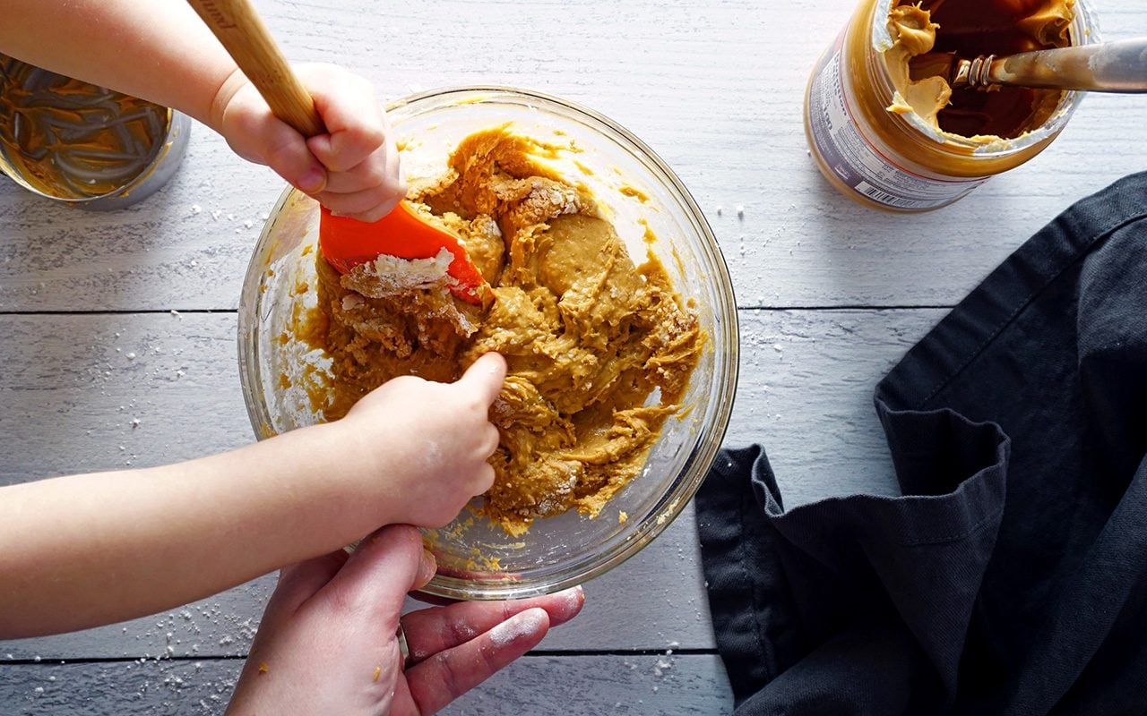mixing peanut butter cup filling with child