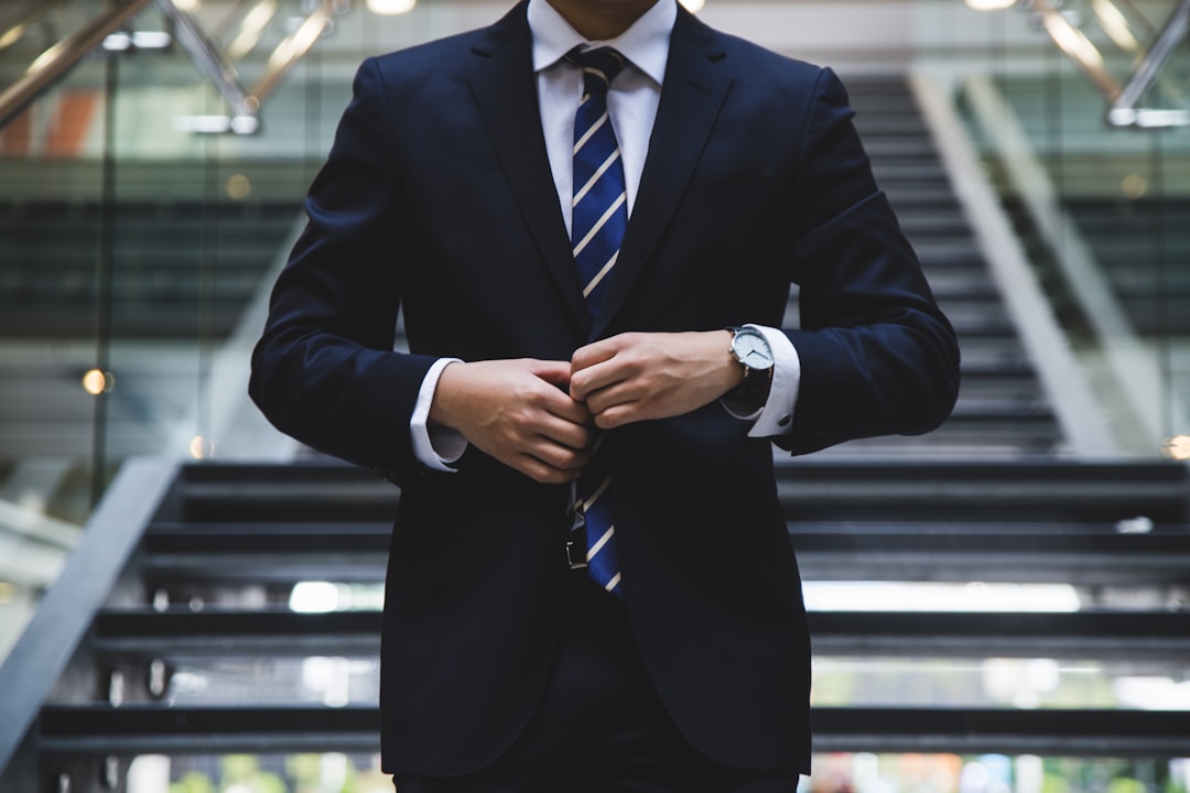 Man in suit adjusting jacket, representing a personal injury lawyer and legal expertise.
