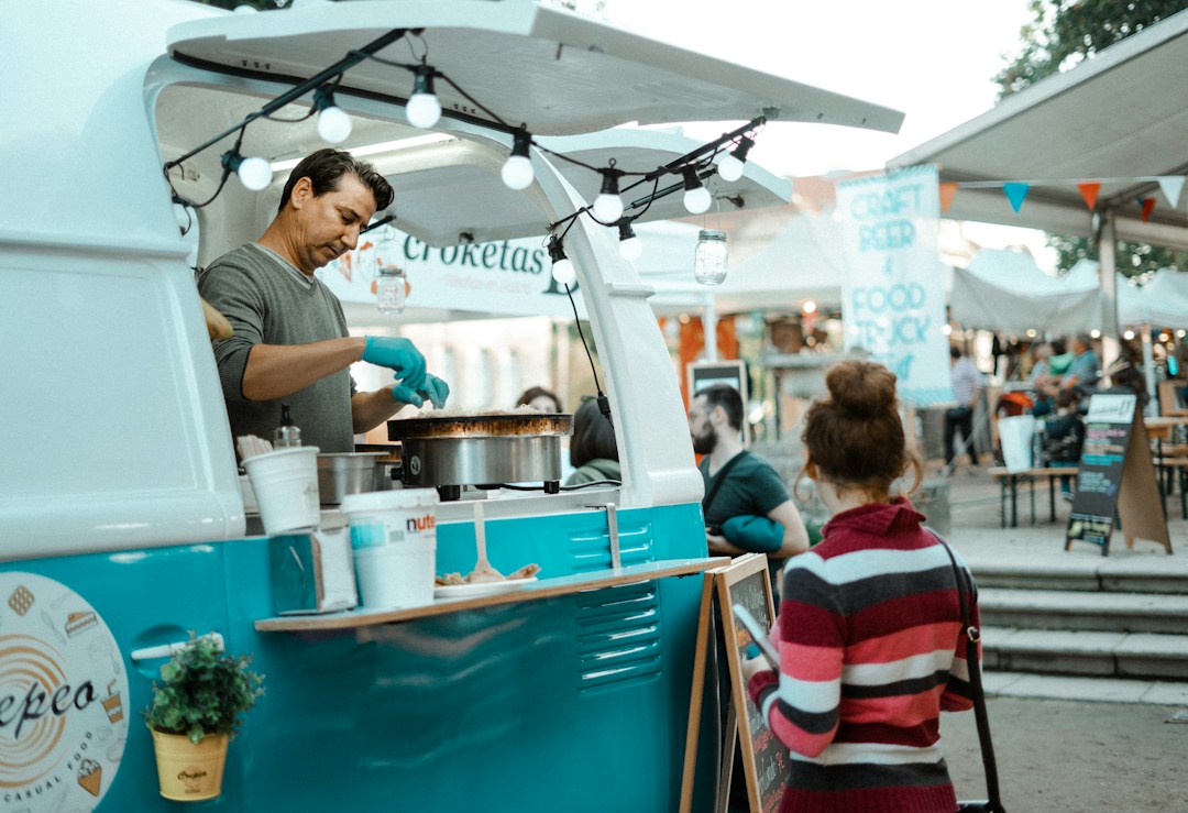 Mobile kitchen restaurant with food preparation and customers.