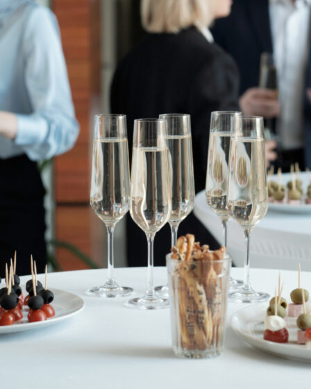 Appetizing canapés and champagne flutes for corporate events and guest experiences.